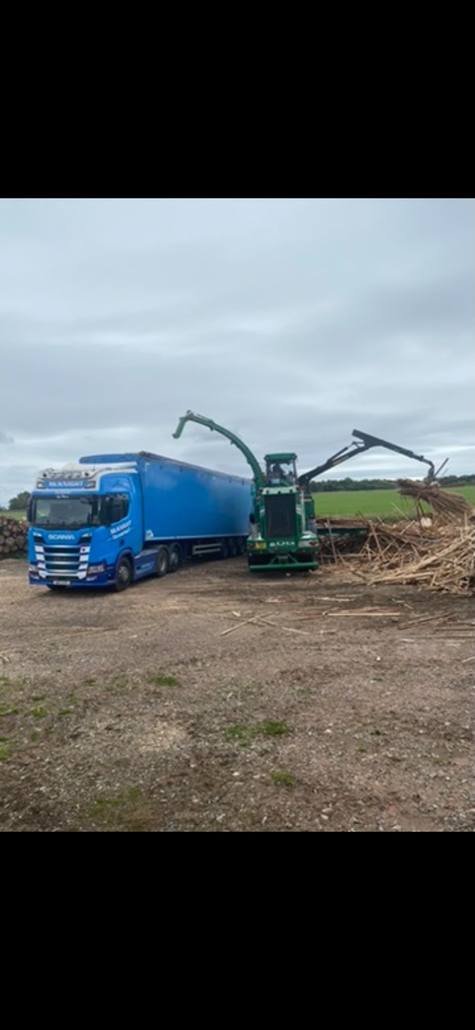 McKnight bulk trailer beside green loading machinery